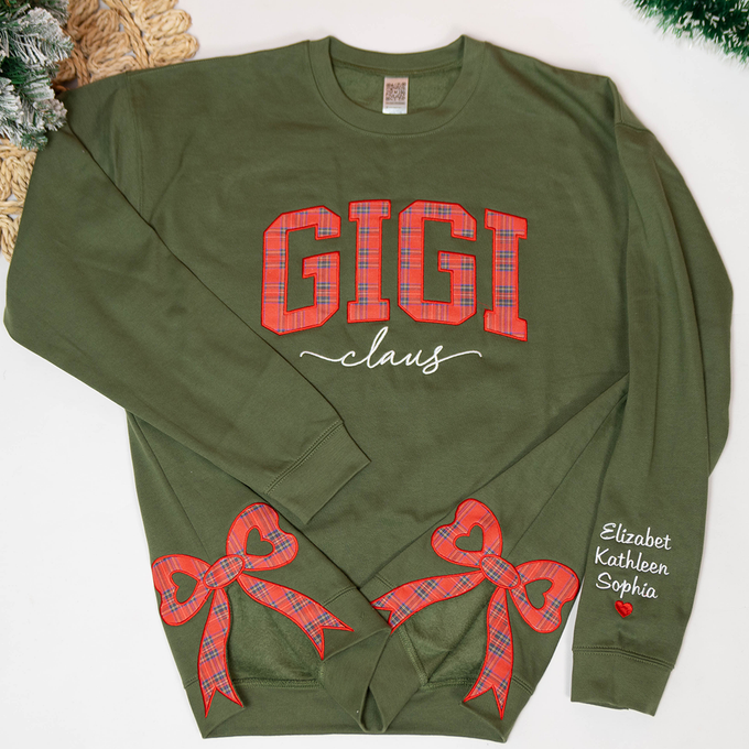 Custom Name Gigi Claus Christmas With Plaid Side Bow Appliqué - Personalized Embroidery Sweatshirt - Gift For Grandma, Mom - NH96